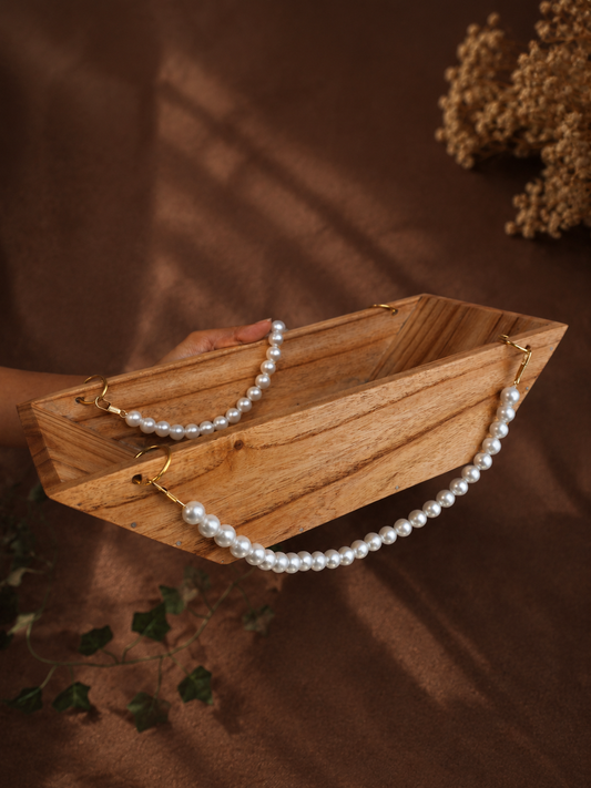 Boat-Shaped Wooden Structure with White Malas and Big Jump Rings
