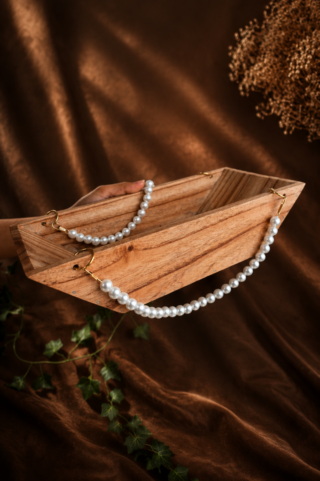 Boat-Shaped Wooden Structure with White Malas and Big Jump Rings