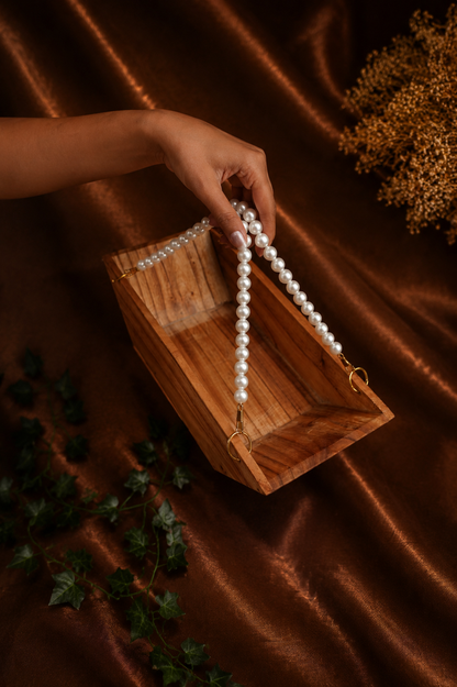 Boat-Shaped Wooden Structure with White Malas and Big Jump Rings